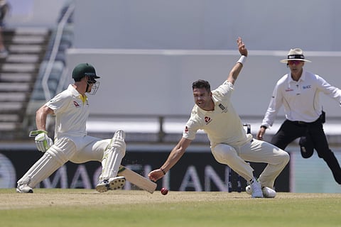 England's James Anderson fields off his own bowling as Australia's Cameron Bancroft scrambles for the crease | AP