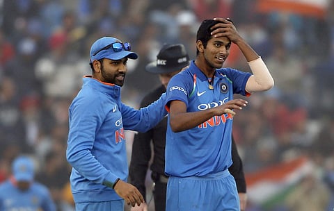 India's captain Rohit Sharma, left, pats teammate Washington Sundar on dismissing Sri Lanka's Lahiru Thirimanne during their second one-day international cricket match in Mohali, India, Wednesday, Dec. 13, 2017. (AP Photo/Altaf Qadri)