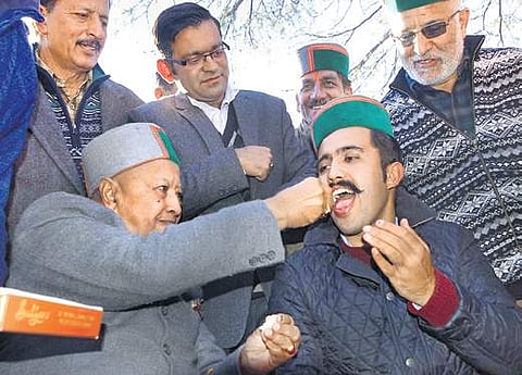 Virbhadra Singh celebrates with his son in Shimla on Monday  | PTI