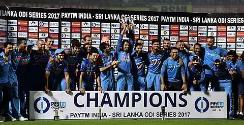 Indian cricket team poses with the trophy after winning the 3rd and final ODI match against Sri Lanka in Vizag on Sunday. India won the series 2-1 . | PTI