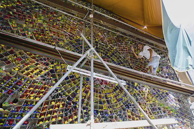 People compete with one another to build the biggest lanterns. The festival draws a large number of tourist because of its popularity. In pic: A man stands on scaffolding made to easily work on huge giant lanterns measuring 20 feet in diameter.  (Photo| AP)