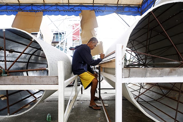 Lantern maker Teddy Aguilar draws wiring patterns on steel cylinders used to manually manipulate the light in each giant lantern.  (Photo| AP)