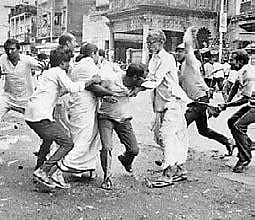 ready to strike a blow  on then Congress leader Mamata Banerjee as other Congress leaders try to protect her in Kolkata on August 16, 1990. | Express