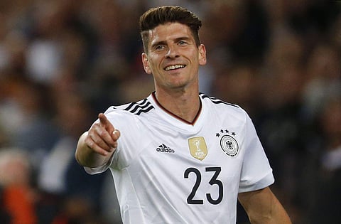 In this Monday, Sept. 4, 2017 photo Germany's Mario Gomez celebrates after scoring his side's sixth goal during the World Cup Group C qualifying soccer match between Germany and Norway in Stuttgart, Germany. | AP