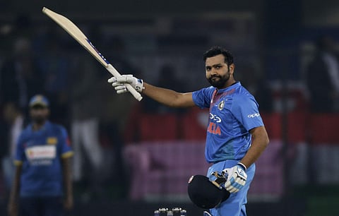 India's captain Rohit Sharma raises his bat to celebrate his century during their second T20 international match against Sri Lanka in Indore. | AP