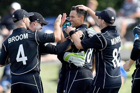 New Zealand's Trent Boult (C) celebrates dismissing West Indies batsman Sheldon Cottrell with his team | AFP