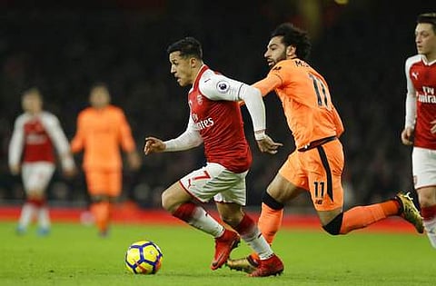 Arsenal's Alexis Sanchez, left vies for the ball with Liverpool's Mohamed Salah during their English Premier League match | AP