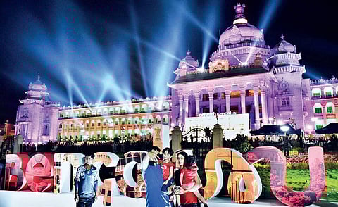 A family poses for a selfie in front of the decked-up Vidhana Soudha at Bengaluru Habba on Sunday  | jithendra m