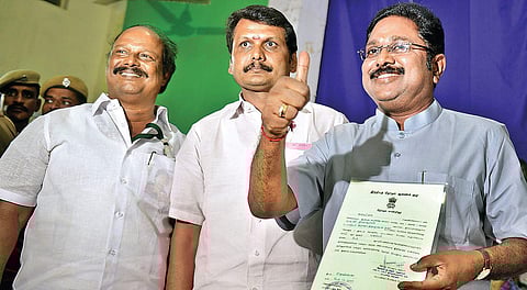 T T V Dhinakaran (right) with the certificate from Returning Officer after winning the bypoll | D SAMPATHKUMAR