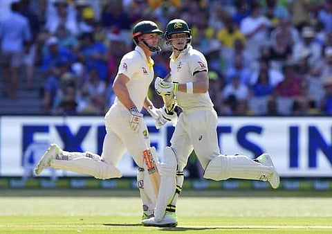 Australia's batsmen Steve Smith, right, and Shaun Marsh make runs against England during their Ashes cricket test match in Melbourne, Australia, Tuesday, Dec. 26, 2017. (AP)