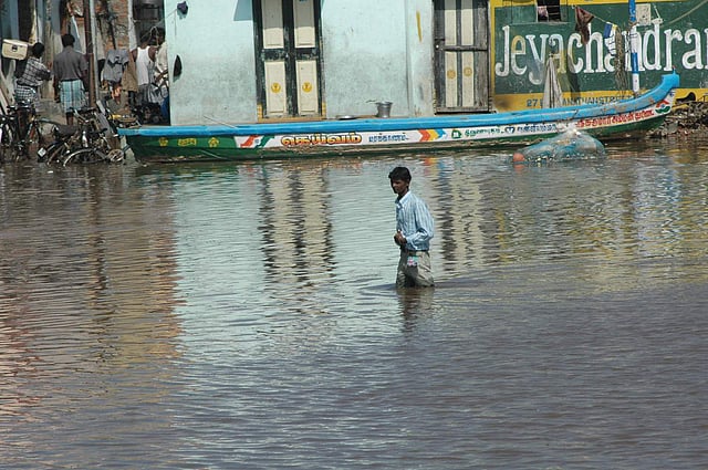 In this December 26, 2004 photo, tidal waves wash through houses. (Express Photo)