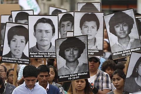 Demonstrators shouts slogans against pardon of former President Alberto Fujimori with photographs of people disappeared during his government, in Lima, Peru, Monday, Dec. 25, 2017. (Photo | Associated Press)
