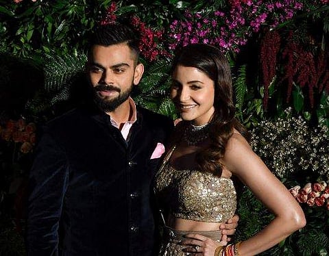 Indian cricket team captain Virat Kohli and his wife actress Anushka Sharma pose for photographers during their wedding reception Mumbai on Tuesday. | PTI