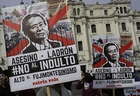 Demonstrators protest against pardon of former President Alberto Fujimori in Lima, Peru, Monday, Dec. 25, 2017.