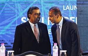Anil Ambani (R), chairman of the Reliance Anil Dhirubhai Ambani Group, talks to his brother Mukesh Ambani, chairman of Reliance Industries Limited, during the launch of 'Digital India Week' in New Delhi.(Photo| Reuters)