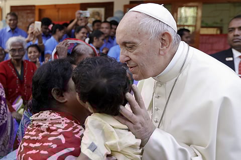 Pope Francis kisses a child as he meets with sick people and staff of the Mother Teresa House in Dhaka's Tejgaon neighborhood, Bangladesh. (AP)