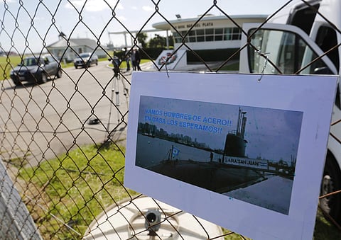 A picture of the Argentine submarine ARA San Juan written in Spanish 'Come on steel men. We will wait for you at home' hangs from the fence at the naval base in Mar del Plata, Argentina. (AP)