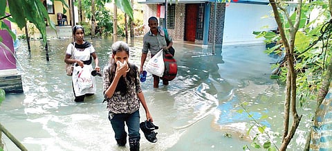 A family moving to a relief camp near Maruvakadu Velankanni Church in Kochi on Saturday | Melton Antony