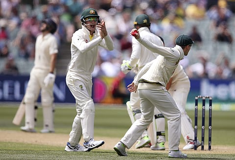 Australia's Steve Smith, right, prepares to throw the ball after catching out England's Alastair Cook for 37 runs during the third day of their Ashes Test match in Adelaide, Monday, Dec. 4, 2017. | AP