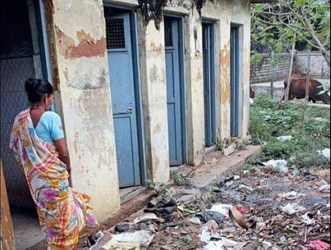Out of the five public toilets for women, one does not have a door and another has the lower half missing. (Express Photo | Manjunath)