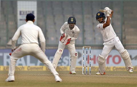Sri Lanka's captain Dinesh Chandimal, right, plays a shot during the third day of their third Test match against India in New Delhi, India, Monday, Dec. 4, 2017. | AP
