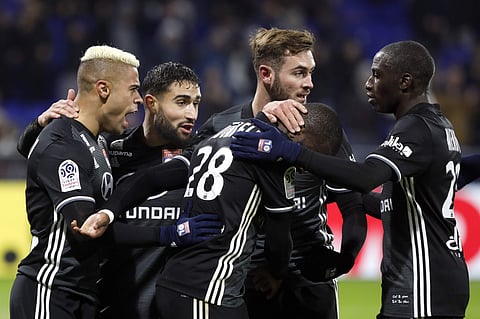 Lyon's Mariano Diaz Mejia, left, and Nabil Fekir, second left, celebrate with their teammates after Diaz scored a goal against Lille during their French League One soccer match in Decines, near Lyon, central France. | AP