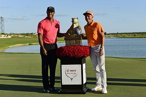 Rickie Fowler, right, poses with Tiger Woods and the trophy after Fowler won the Hero World Challenge golf tournament at Albany Golf Club in Nassau, Bahamas, Sunday, Dec. 3, 2017. | AP