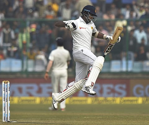 Sri Lanka's Angelo Mathews celebrate his century against India during the third day of third Test match at Firozshah Kotla in New Delhi on Monday. | PTI