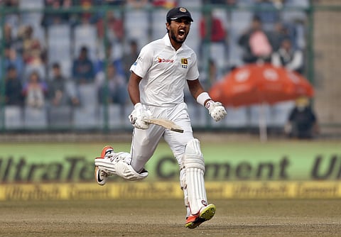 Sri Lanka's captain Dinesh Chandimal celebrates scoring a century during the third day of their third Test match against India in New Delhi, India, Monday, Dec. 4, 2017. | AP