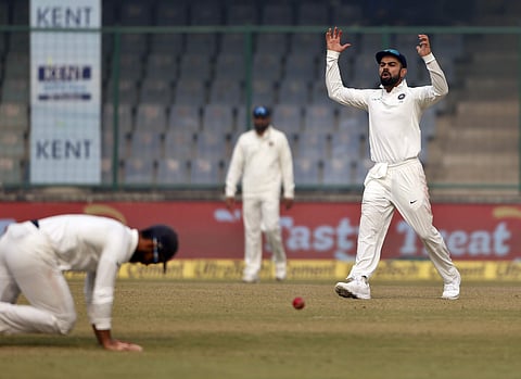 India's captain Virat Kohli reacts after a catch dropped by teammate Ajinkya Rahane, left, during the third day of their third Test match against Sri Lanka in New Delhi, India, Monday, Dec. 4, 2017. | AP