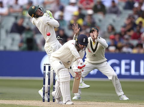 A bouncing delivery has England's Mark Stoneman, front, and Australia's Tim Paine, left, beaten during the fourth day of their Ashes Test match in Adelaide, Tuesday, Dec. 5, 2017. | AP