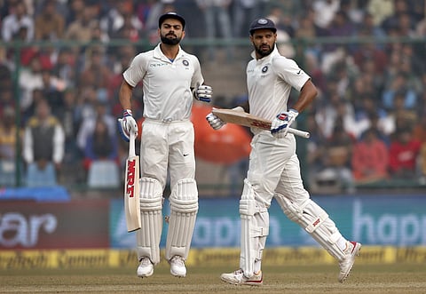 India's captain Virat Kohli, left, and Shikhar Dhawan run between the wickets during the fourth day of their third Test match against Sri Lanka in New Delhi, India, Tuesday, Dec. 5, 2017. | AP