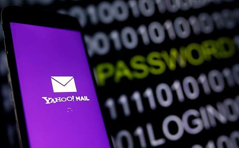 Yahoo Mail logo is displayed on a smartphone's screen in front of code in this illustration picture | REUTERS