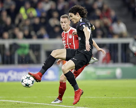PSG's Edinson Cavani, front, and Bayern's Joshua Kimmich challenge for the ball during the Champions League Group B soccer match between FC Bayern Munich and Paris Saint-Germain, at Allianz Arena stadium in Munich. | AP