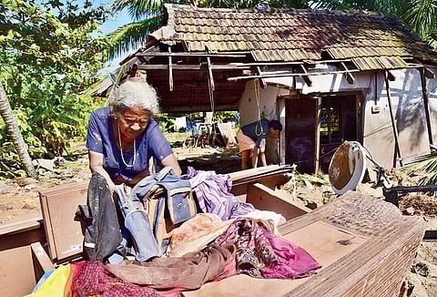 Kunjamma Joseph, 74, of Nayarambalam panchayat in Vellithanparambu beach on the Vypeen-Cherai stretch, going through her belongings while standing in front of her house which was destroyed in cyclone Ockhi. She returned after her stay at a relief camp on 