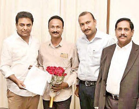 Textiles minister KT Rama Rao presenting the sanction letter of ` 1 crore to  Chintakindi Mallesham in Hyderabad on Tuesday.  | Express photo