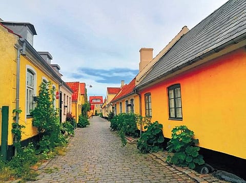 Clockwise from above: Old Town of Dragor with its sea of yellow houses; the harbour; an old vessel at the open museum