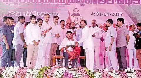 Chief Minister K Chandrasekhar Rao felicitating the Managing Director of Megha Engineering Infrastructure Limited PV Krishna Reddy at Tirumalayapalem mandal headquarters on Tuesday. | Express