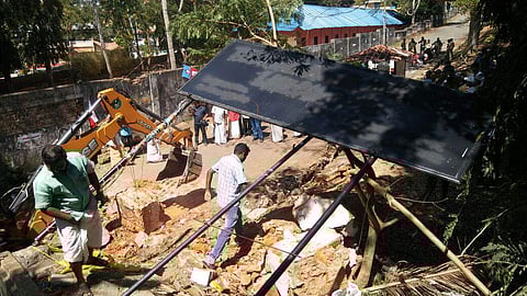 Revenue officers demolishing the pillars of the main entrance of Law Academy Law College in Thiruvananthapuram on Sunday | Express