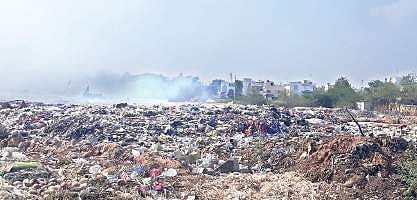 The heaps of solid waste piled up for the last two weeks at the Excel Plant owned by Vijayawada Municipal Corporation | Express