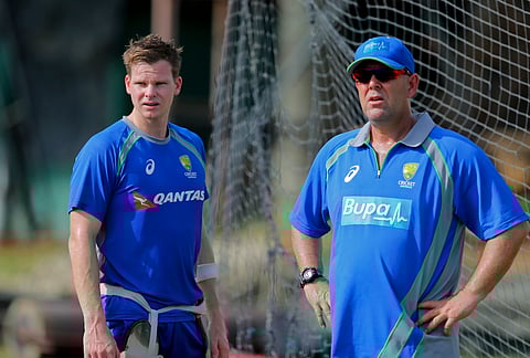 Australian cricket captain Steven Smith, left, and coach Darren Lehmann chat during a practice session in Colombo, Sri Lanka. | AP File Photo