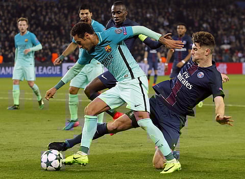 Barcelona's Neymar, front, battles for the ball with PSG's Thomas Meunier during the Champion's League round of 16, first leg soccer match between Paris Saint Germain and Barcelona at the Parc des Princes stadium in Paris, Tuesday, Feb. 14, 2017. | AP