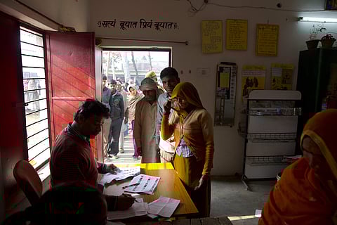An election official checks the identity of a woman before she casts her vote at a polling station near Amroha, Uttar Pradesh, India, Wednesday, Feb. 15, 2017. | AP