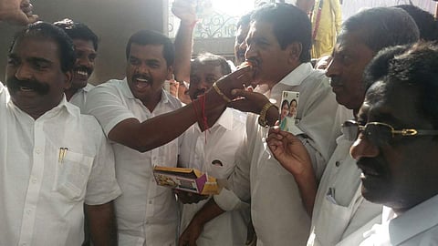 Party members celebrate Palanisamy's victory by eating and distributing sweets at the party headquarters. | EPS