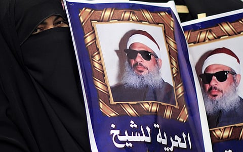 In this Feb. 26, 2012 file photo, Egyptian protesters hold posters showing Sheikh Omar Abdel-Rahman, who is imprisoned in the US, and call for his release outside a court in Cairo, Egypt.  | AP