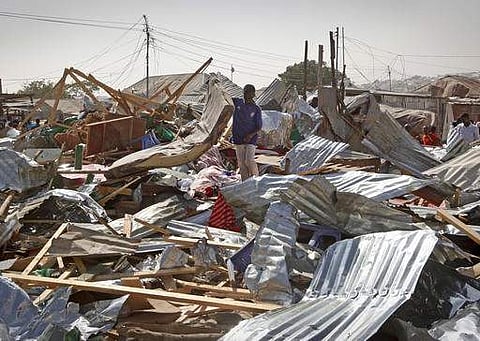 A shopkeeper surveys the wreckage of shops destroyed by a blast in a market in the capital Mogadishu, Somalia on February 19. (Photo | AP)