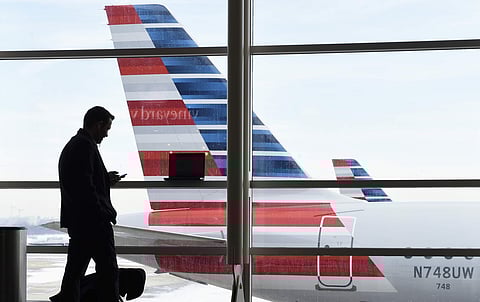 A passenger talks on the phone at Washington's Ronald Reagan National Airport. (File Photo | AP)