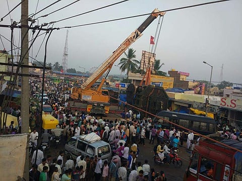 A crane lifting the toppled chariot at Kottur town in Ballari district on Wednesday. (Photo | EPS)