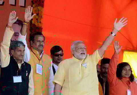Prime Minister Narendra Modi waves during an election campaign rally in Bahraich district of UP on Thursday | PTI