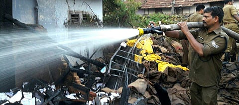 Firemen dousing fire at parcel godown of post office located at the North gate of Padmanabha Swamy temple in Thiruvananthapuram on the wee hours of Sunday.(Kaviyoor Santhosh | EPS)